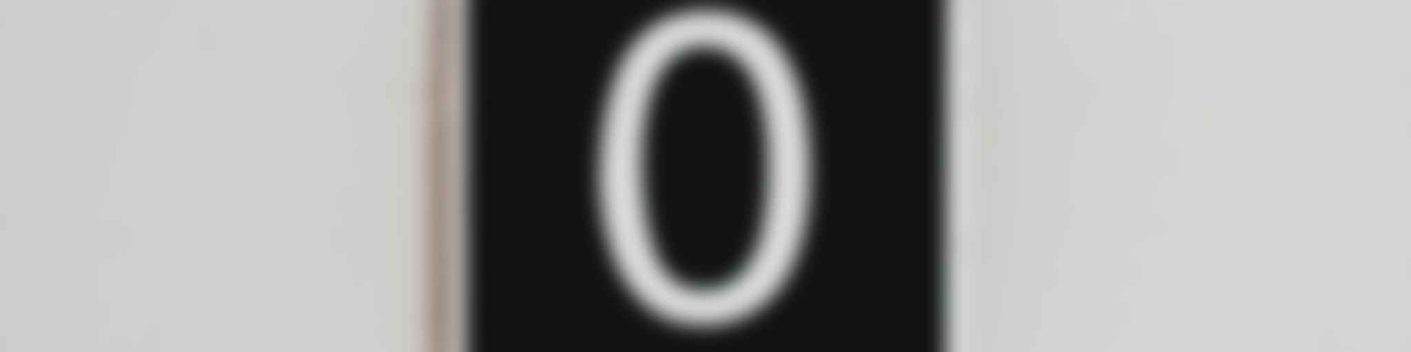 A zero on a sign on the wall