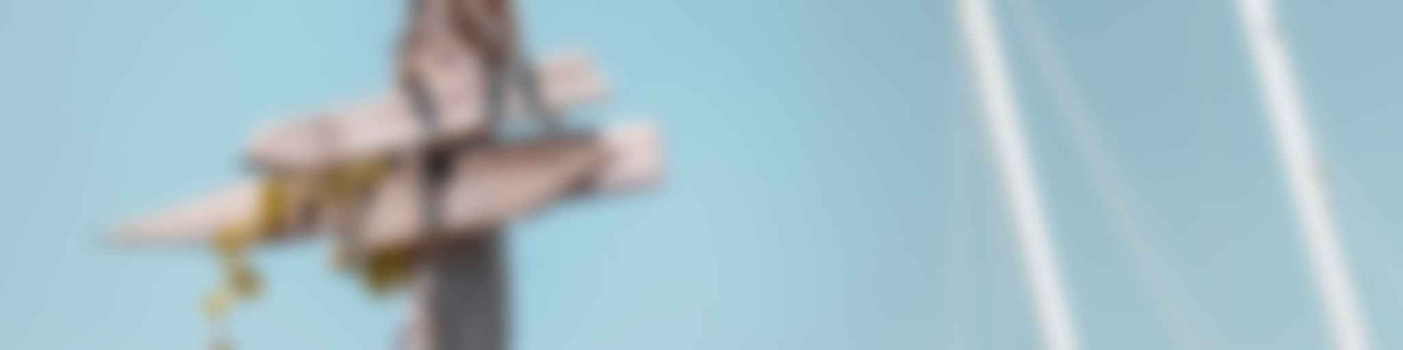 Wooden signposts pointing in different directions on a beach